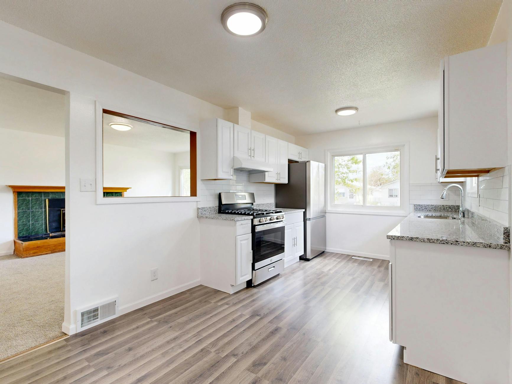 Luxury kitchen renovation with white cabinets and hardwood floors
