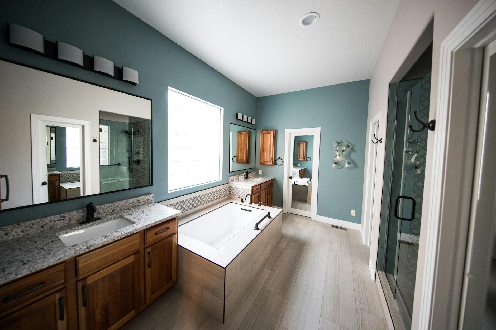Luxury bathroom remodel with freestanding tub and granite counters